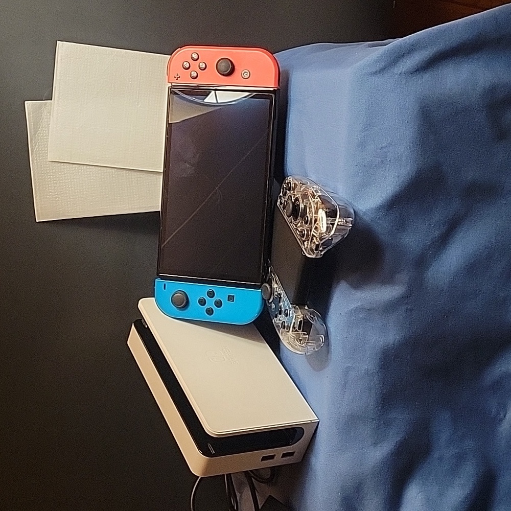 Nintendo Switch OLED  with Neon Blue and Red Joy-Con Controllers.